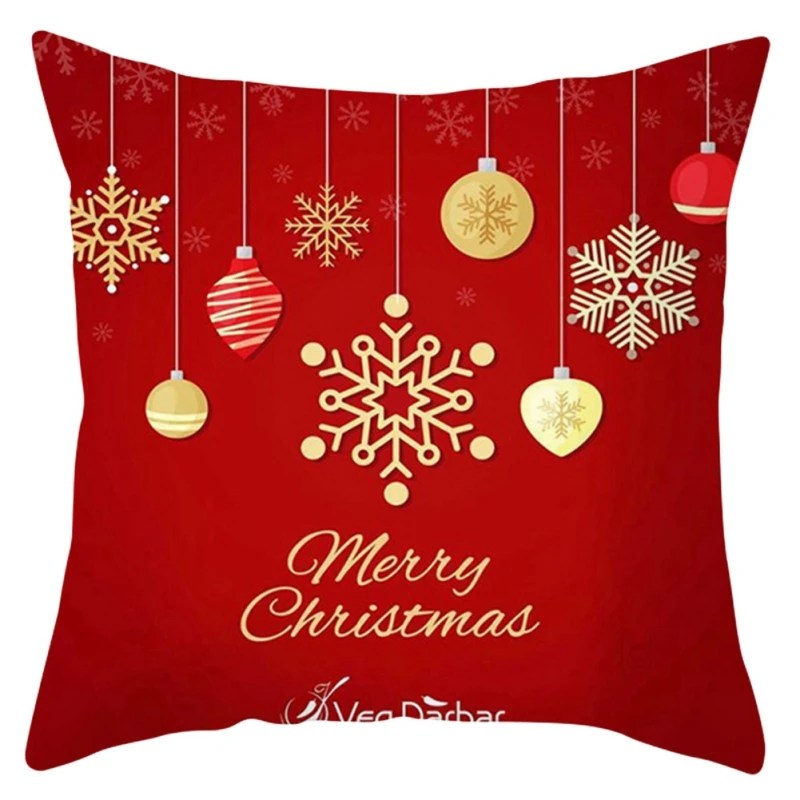 Un cojín decorativo con temática navideña. La almohada tiene un fondo rojo con un estampado de copos de nieve y adornos navideños. En el centro, hay un gran diseño de copo de nieve con el texto Feliz Navidad escrito en una fuente cursiva festiva.