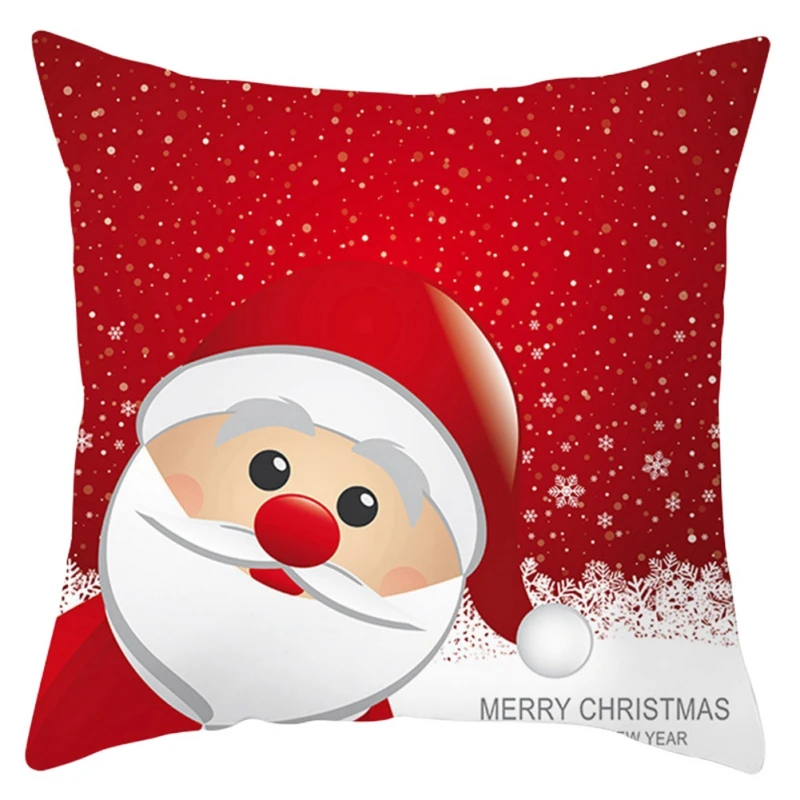 Un cojín decorativo con temática navideña. La almohada presenta una ilustración de dibujos animados de la cara de Papá Noel, con una nariz roja, barba blanca y un sombrero rojo con un pompón blanco. El fondo de la almohada es rojo con un patrón que se asemeja a los copos de nieve que caen.