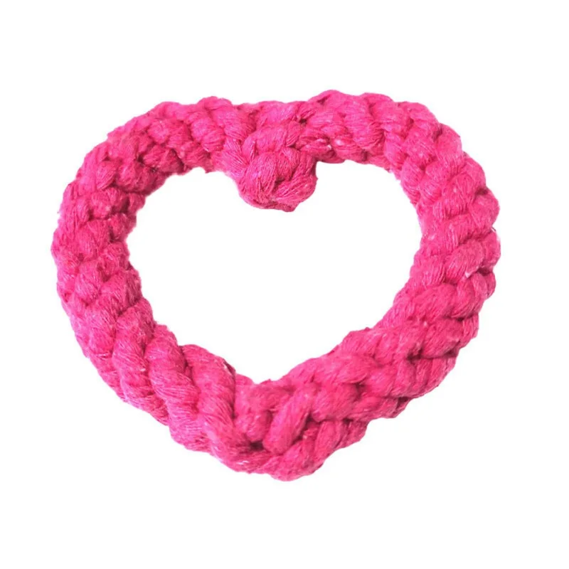 Un objeto en forma de corazón hecho a crochet o tejido. Parece estar hecho de hilo y el color es rosa brillante. El corazón está diseñado con una serie de puntadas que le dan una apariencia texturizada.