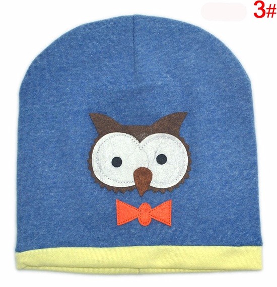sinine laste müts öökulli aplikatsiooniga ja kollase äärega