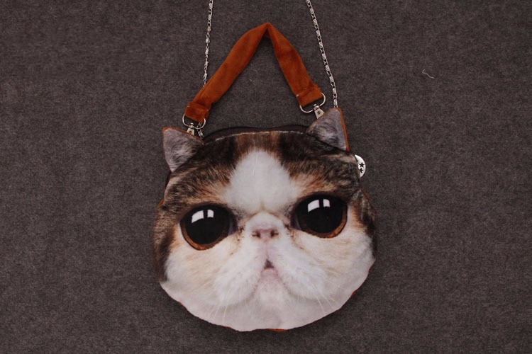 ümar õlakott suure kassi näo pildiga, pruunide sangade ja ketiga