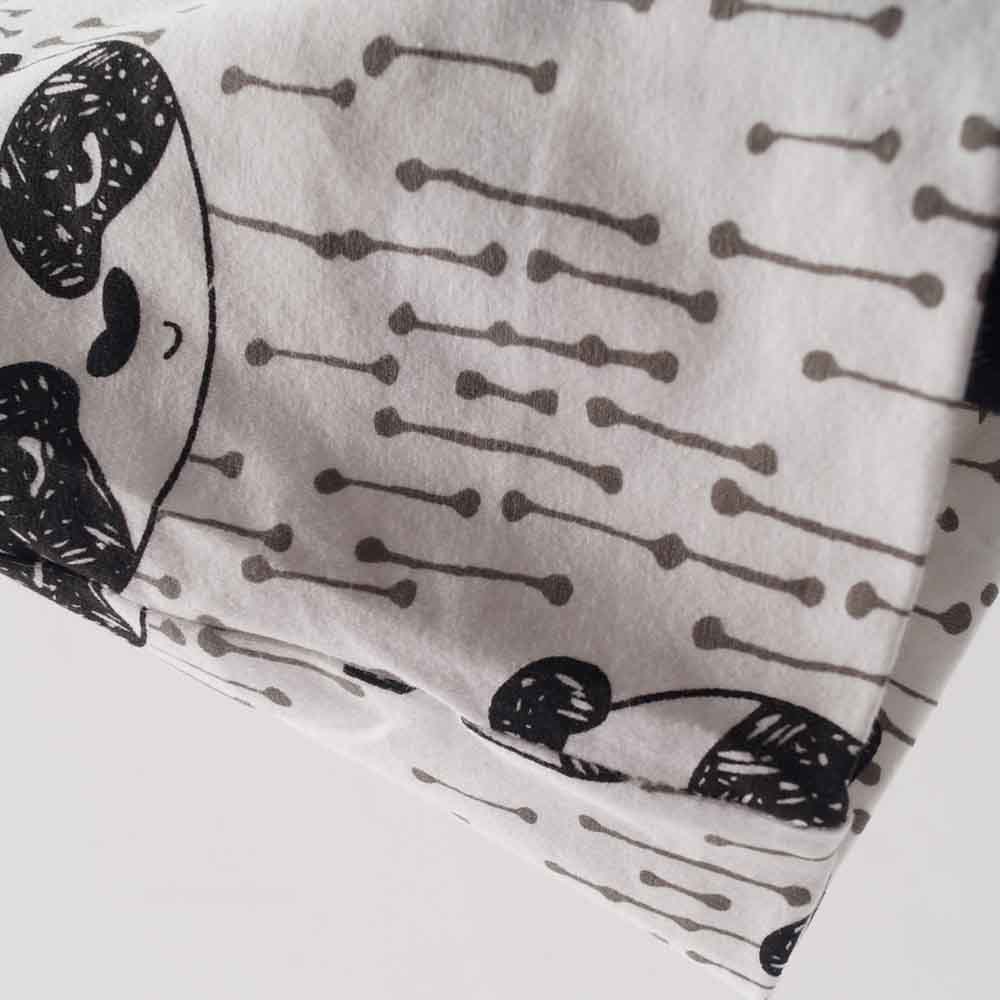 valge beebimüts mustade pandakujutiste ja triipudega