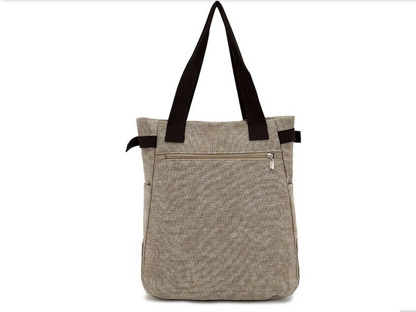 beež õlakott mustade sangadega ja lukuga tasku esiküljel