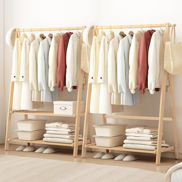 Colorful Wooden Cloth Hangers On Clothes Rail In White Wardrobe