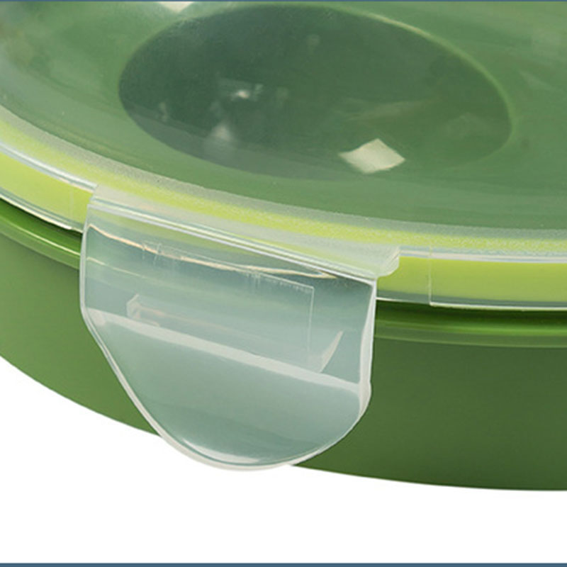 Close-up of an Avocado Crisper Box Airtight, featuring a green plastic design with a transparent lid. The snap-lock closure is prominently displayed along the edge, highlighting its secure locking mechanism for optimal avocado storage.