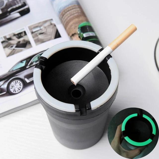 Ashtray in the car full of cigarette ends and ash Stock Photo