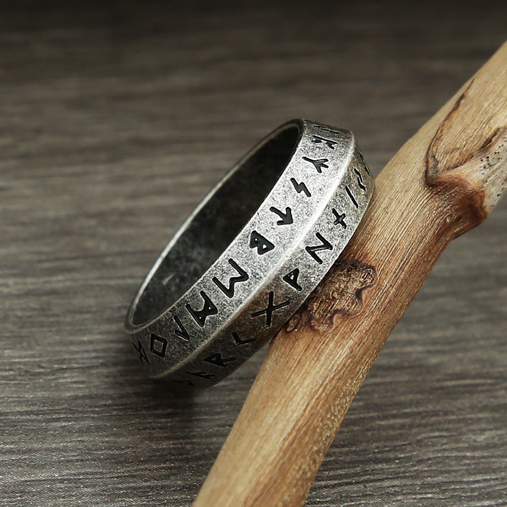 Close-up of stainless steel Viking ring on hand