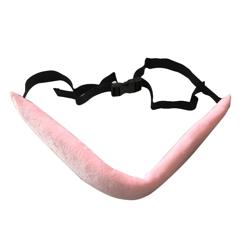 A pink plush cushion featuring a V-shaped design and an adjustable black strap and buckle, similar to the High Chair Security Straps for infants and toddlers. It is likely a comfortable wearable item offering ergonomic support as a neck or head rest with its versatile fit.