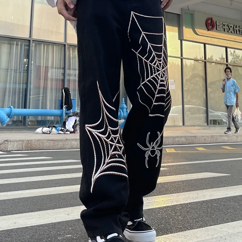 Men's fashion streetwear with spider web wide leg jeans featuring oversized zip hoodie, big watches, and trendy shoes1