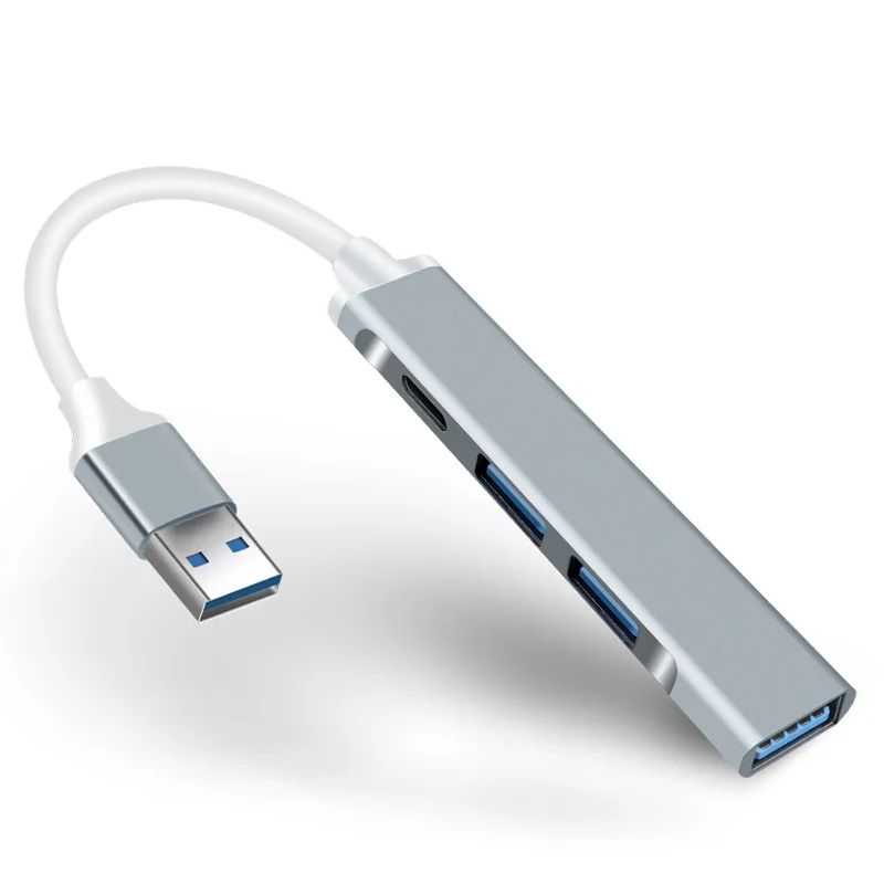 Un cable USB blanco está conectado a un dispositivo plateado