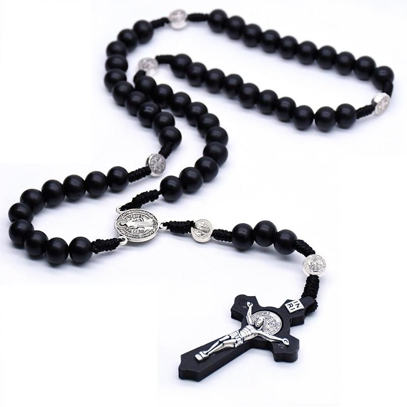 Close-up of the wooden cross and Saint Benedict car pendant
